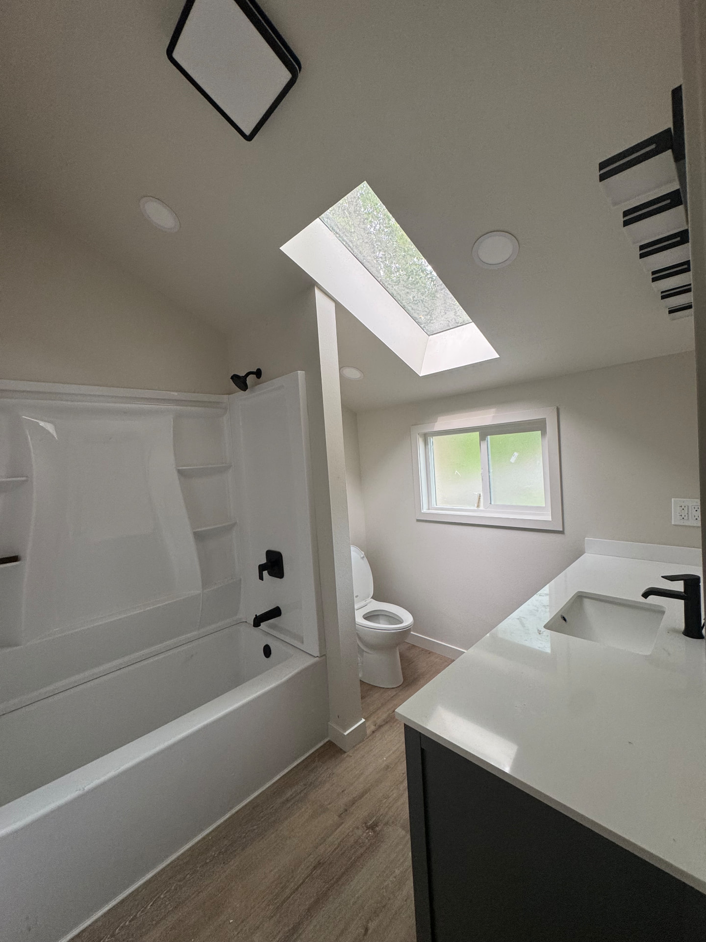 Bright remodeled bathroom with skylight
